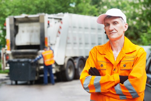 Workers collecting household waste for removal